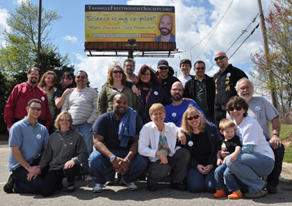 FFRF Raleigh chapter members in front of the chapter president's billboard.