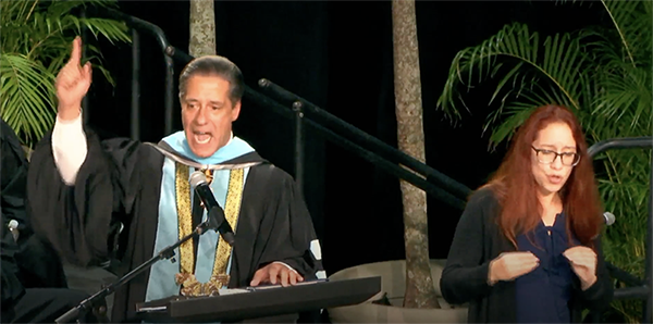 A religious person giving a speech with an ASL interpretor 