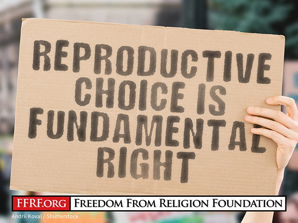Person holding a sign that reads "Reproductive Choice is a Fundamental Right"