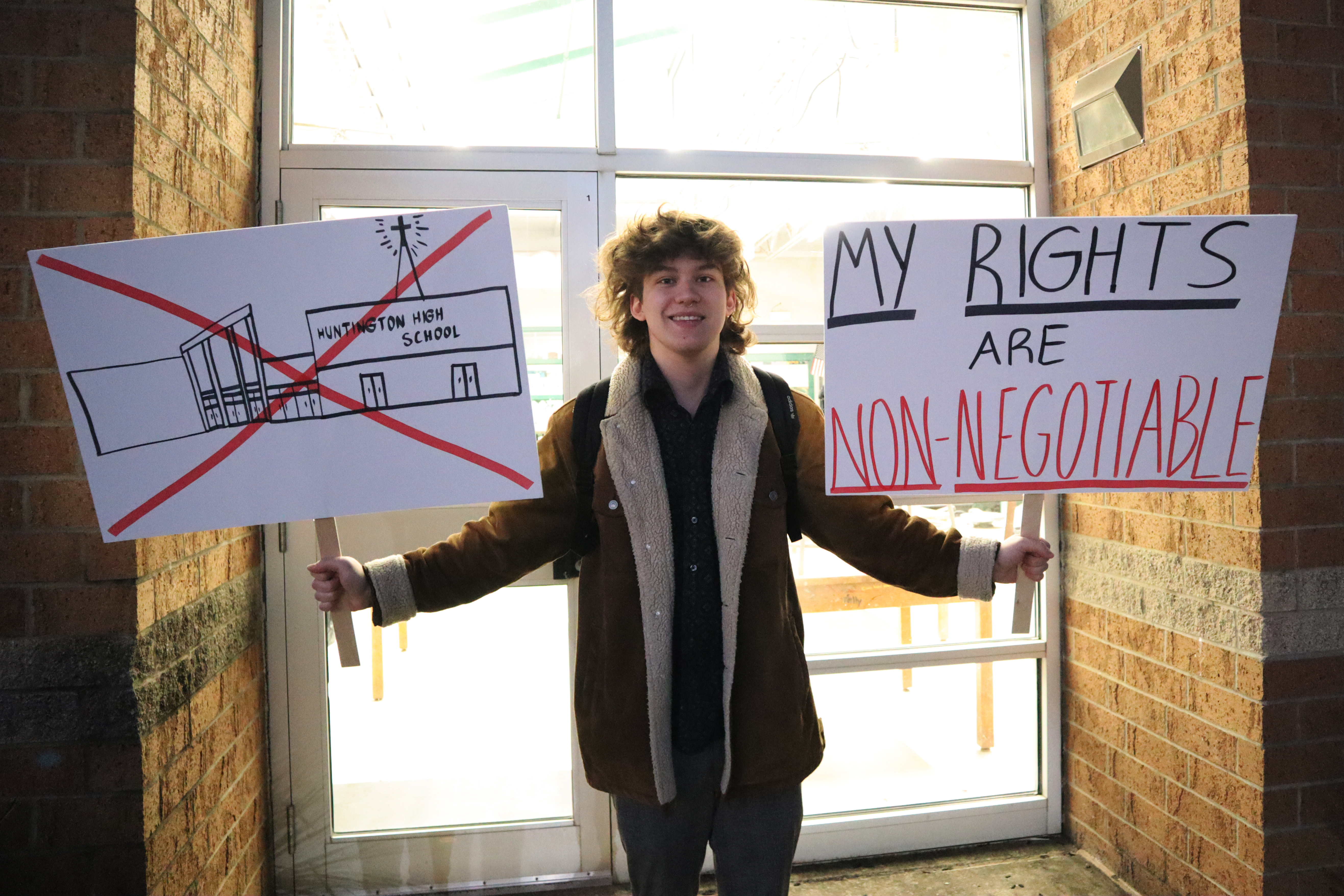 Photo of student protester holding signs