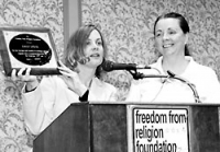 Foundation staff member Annie Laurie Gaylor presenting the plaque to Emily Lyons (at right).