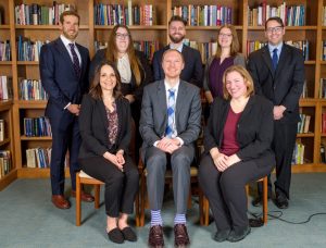 The FFRF legal staff posing together in front of bookshelves