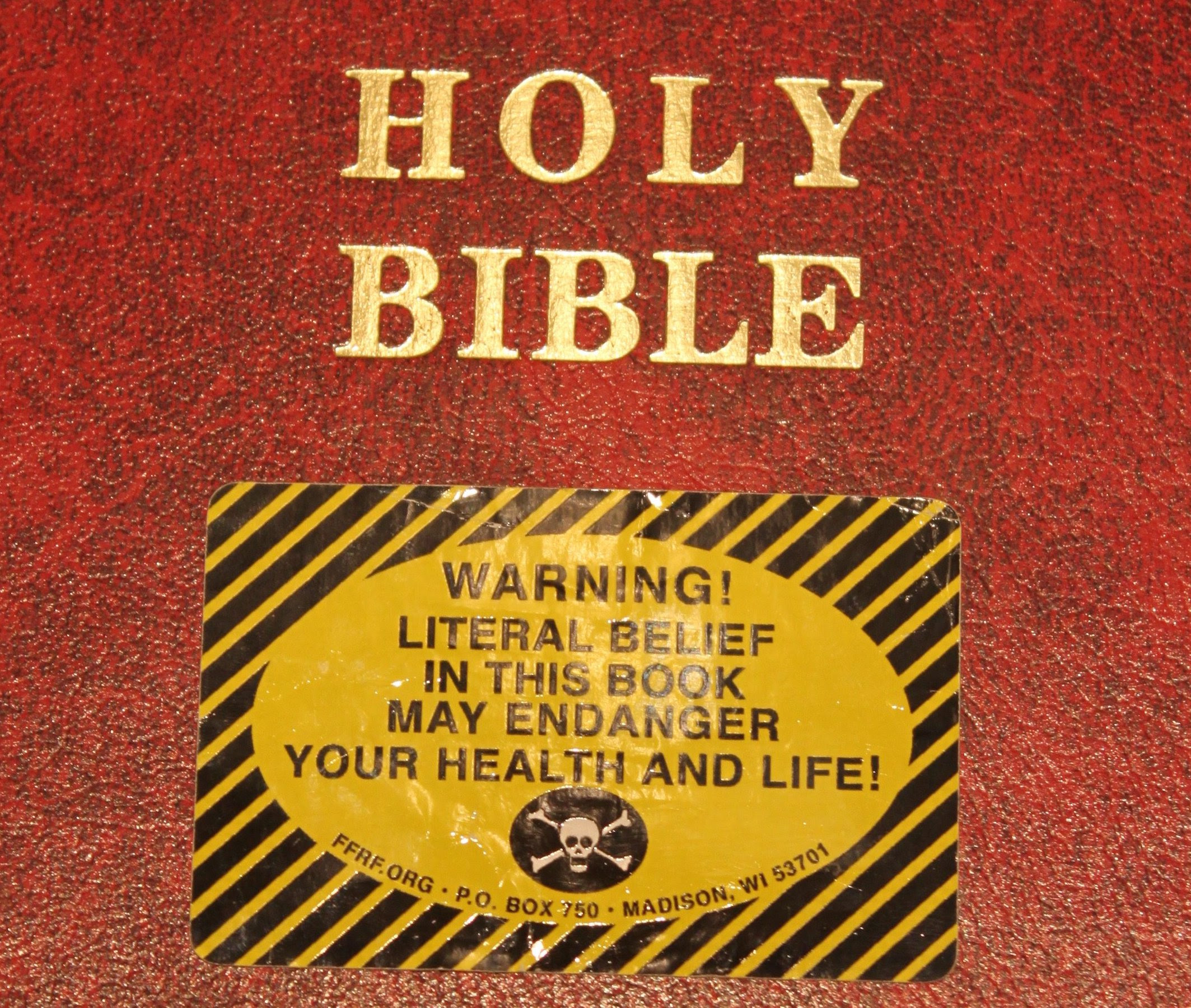 A bible with a warning sticker on it