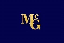 McG written in gold against a dark blue backdrop